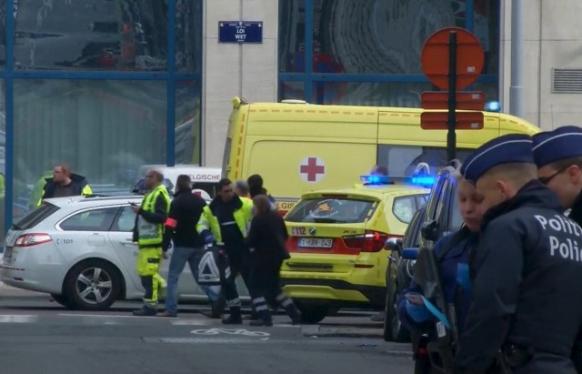 Still image taken from video of emergency personnel at the scene of a blast outside a metro station in Brussels